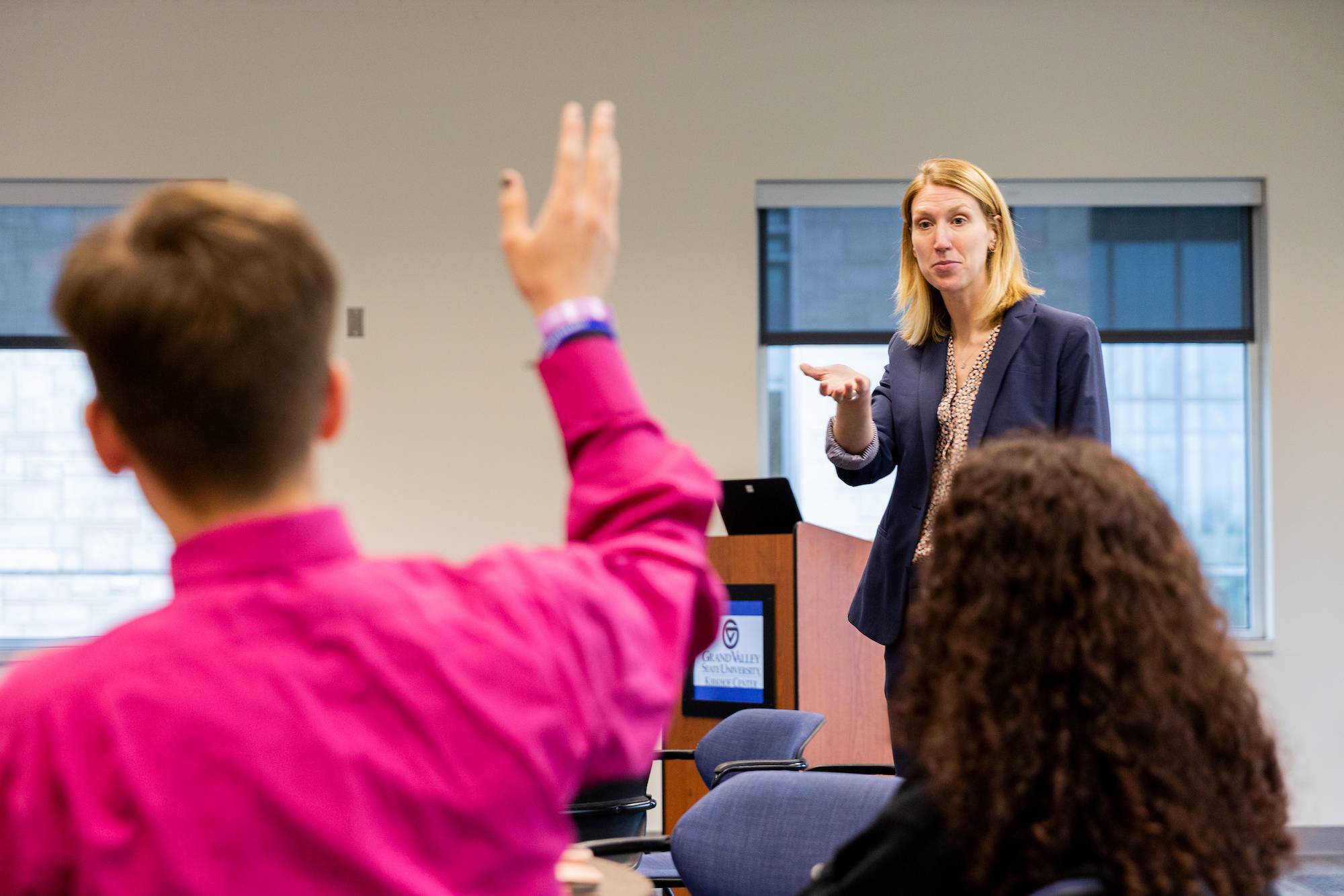 A speaker choosing a student who has their hand up
